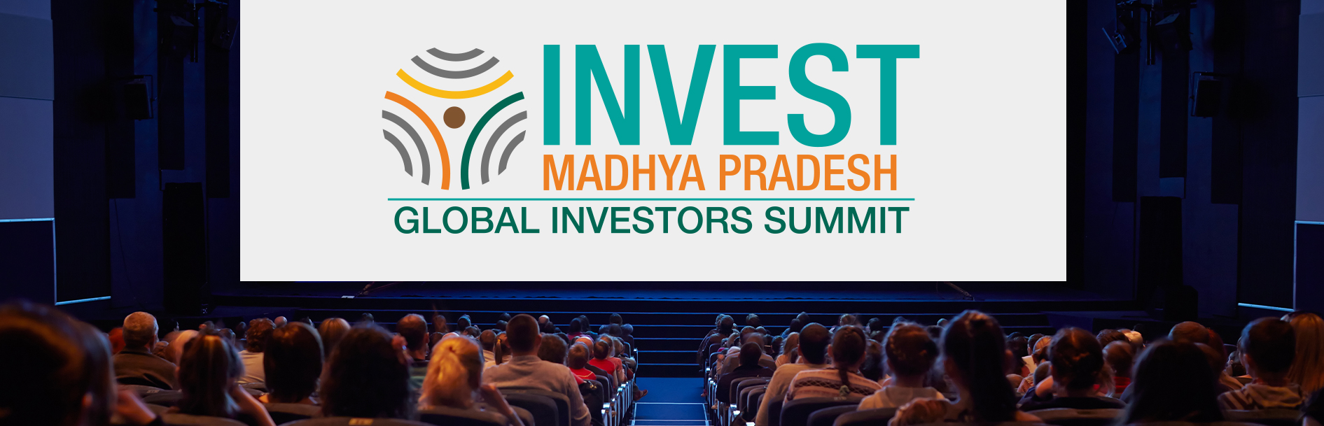 Large screen displaying the Invest Madhya Pradesh logo and Global Investors Summit text, seen from the back of a crowded auditorium.